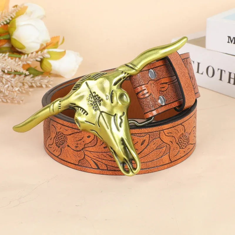 Men's brown leather-look belt with a detailed metal cow head buckle showing carved and embossed details.