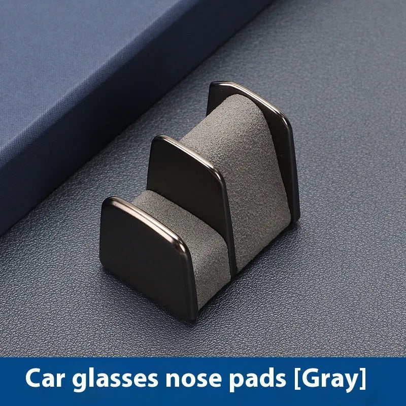 Green zinc alloy and leather glasses clip holder mounted on a car dashboard.