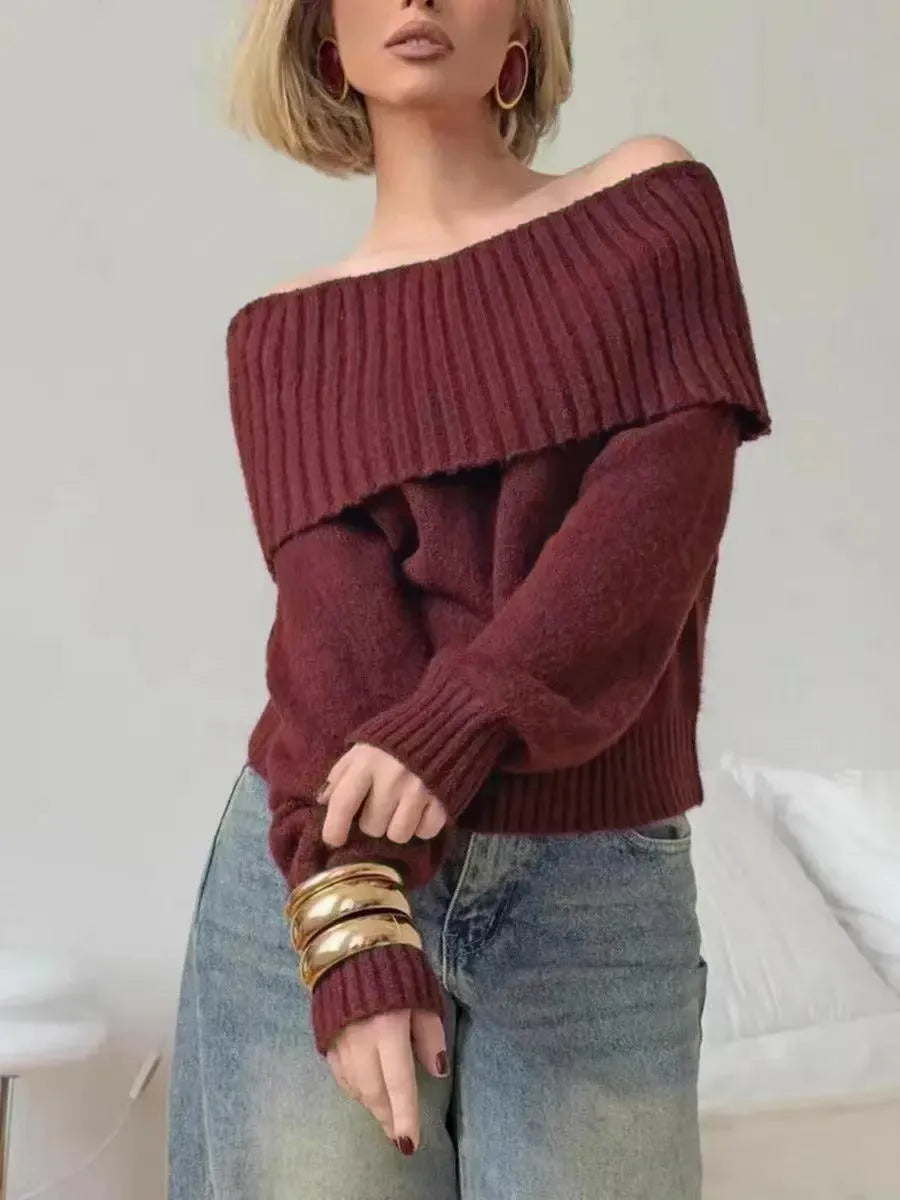 Woman wearing a grey off-the-shoulder strapless sweater with a 3D textured pattern.