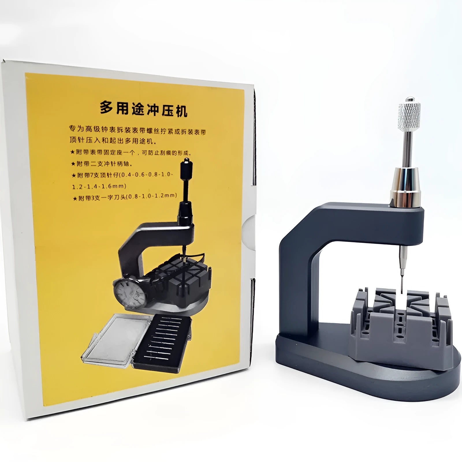 Silver tool steel multi-purpose press strap removal tool for watches and electronics on a workshop surface.