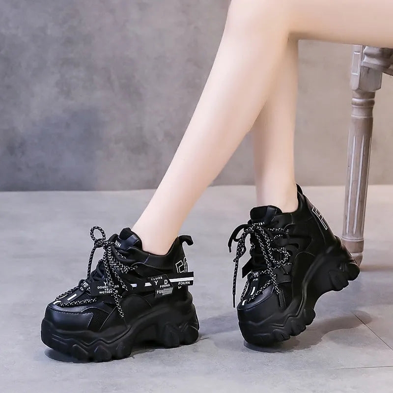 White women's mesh platform tennis shoes with cross strap and a thick rubber sole.