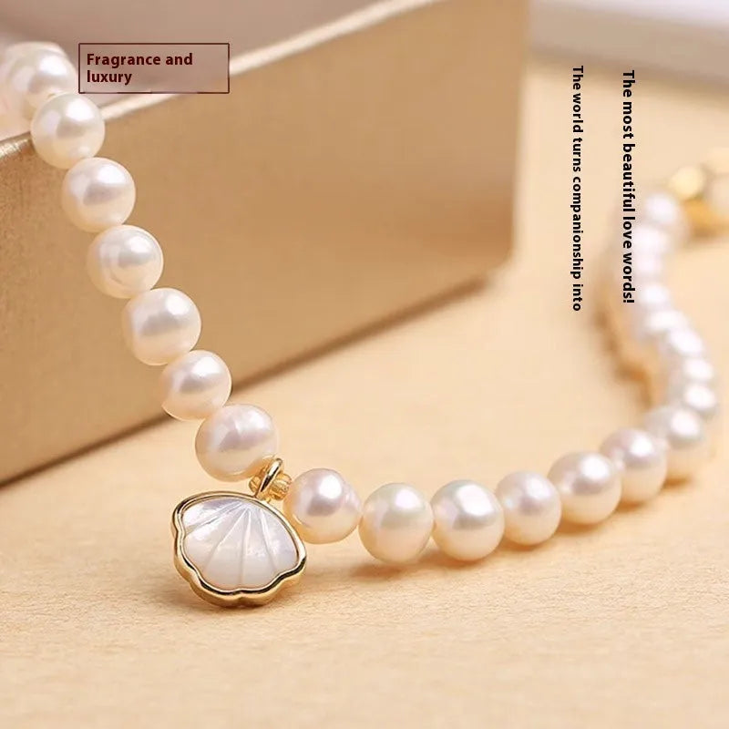 A women's freshwater pearl bracelet with a fan-shaped design, shown in 16cm length with elastic and chain options.