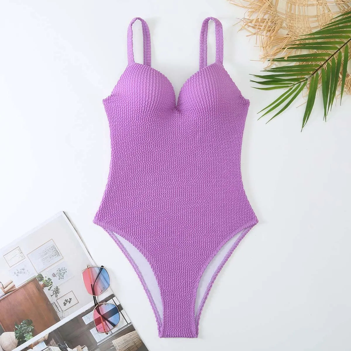 Women's black sunk-stripe one-piece swimsuit made from polyester fabric, sleeveless design.