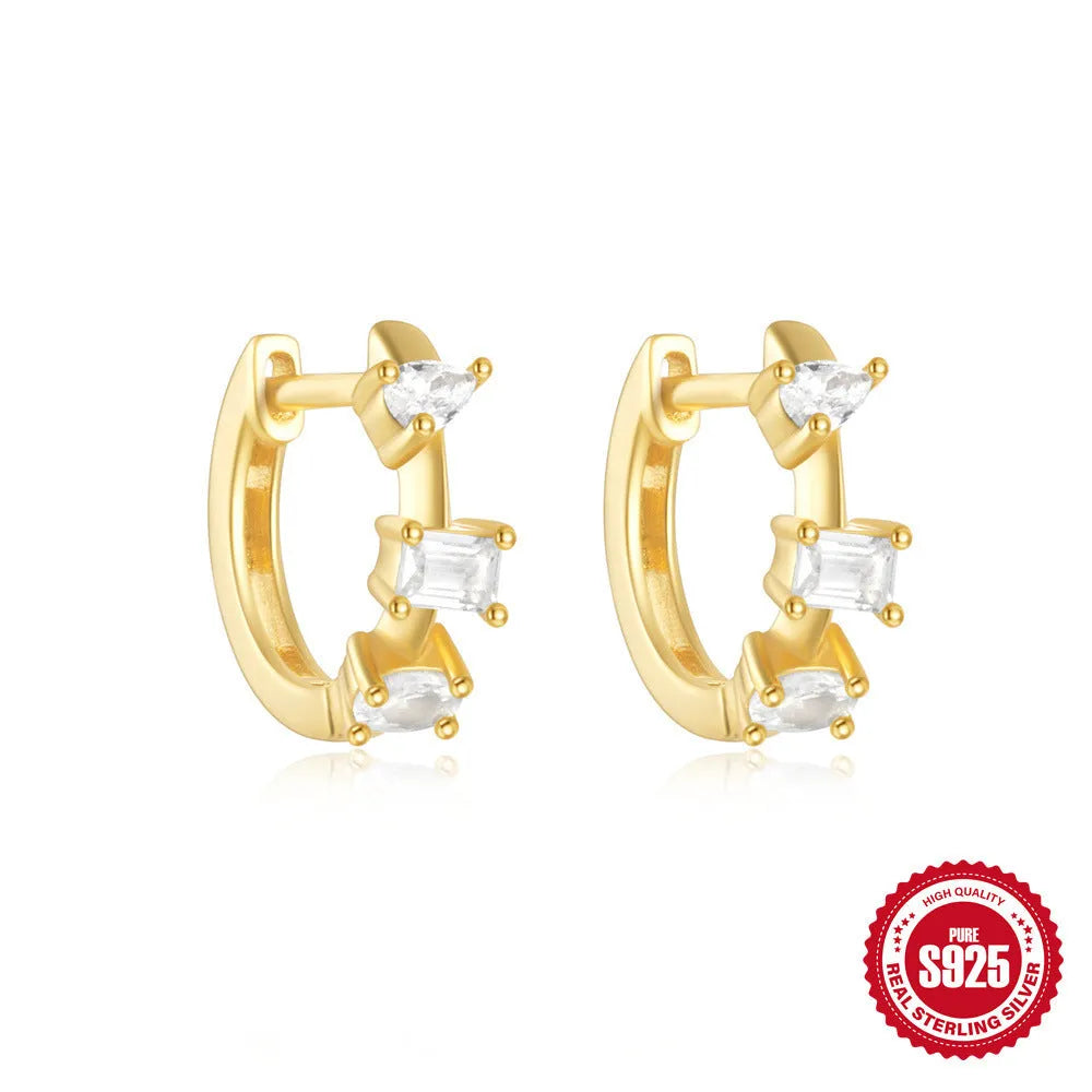 Sterling silver geometric stud earrings with a small round shape and classic diamond detail on a white background.