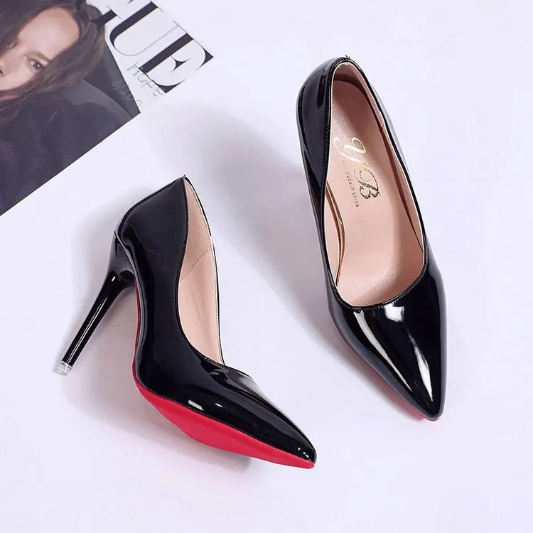 Women's black pointed toe stiletto heel pumps with a shallow mouth design on a plain background.