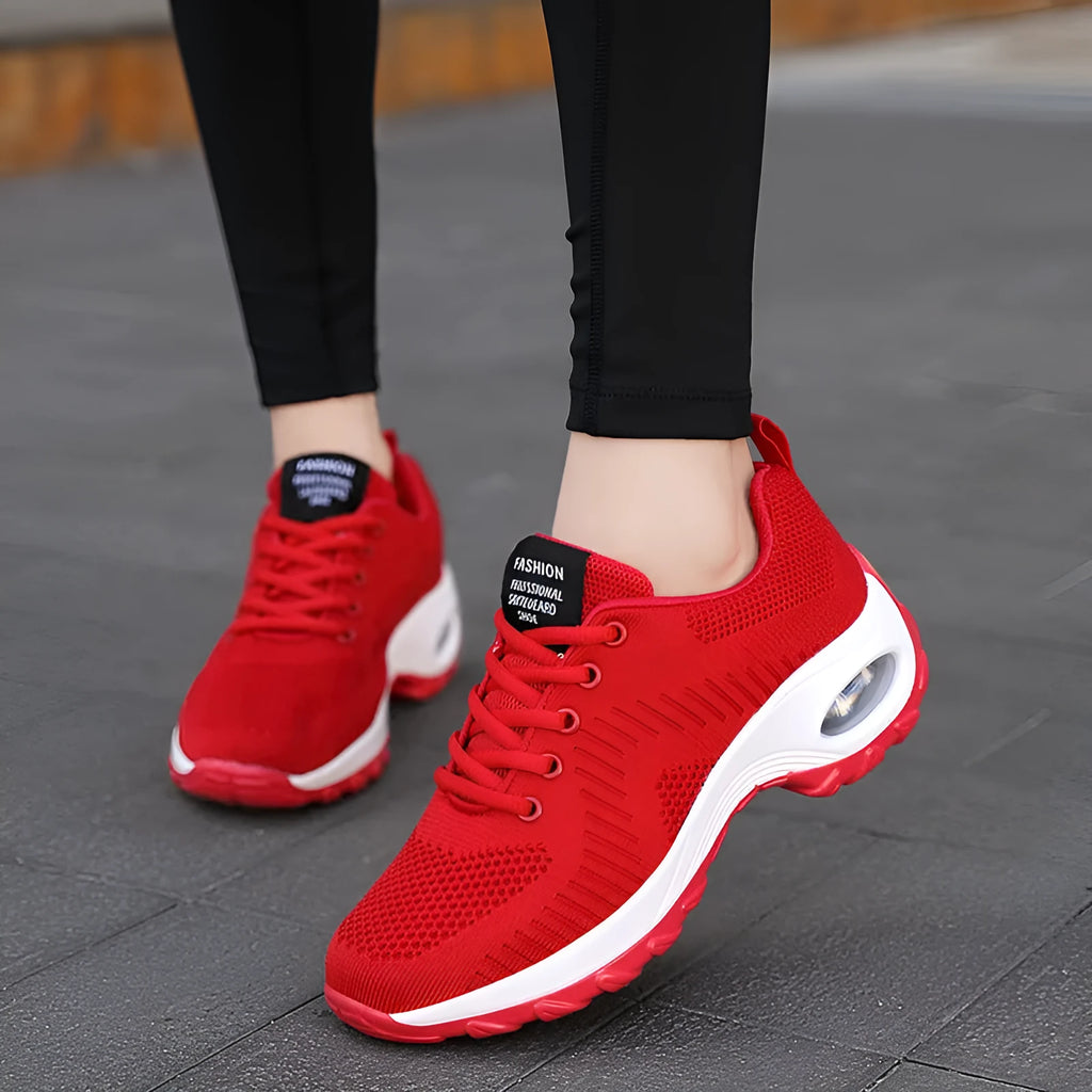 Women's black mesh sneakers with round toe and front lace-up closure showing flat heel design