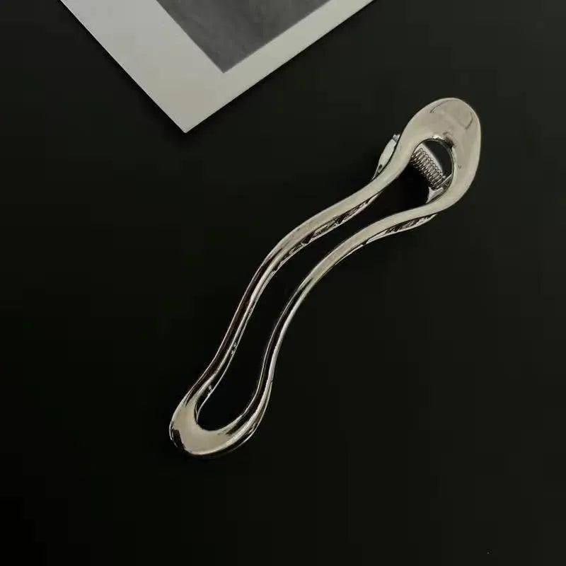 Gold and silver zinc alloy hair barrettes in square, arc, and triangle shapes.