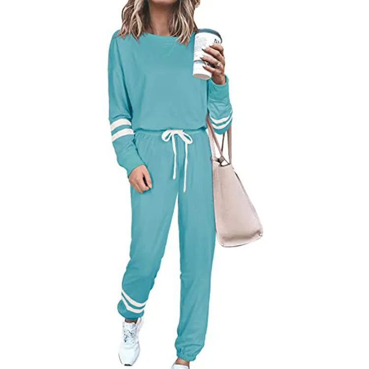 Women's plus size casual suit set in loose-fitting design with half-sleeve top and solid colour trousers