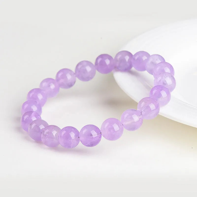 Lavender amethyst bracelet with round beads in a water ripple pattern, showing cream body and transparent colour options.