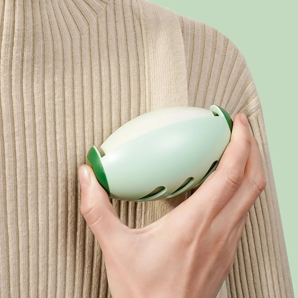 Green and white reusable gel lint roller ball for portable pet hair removal.