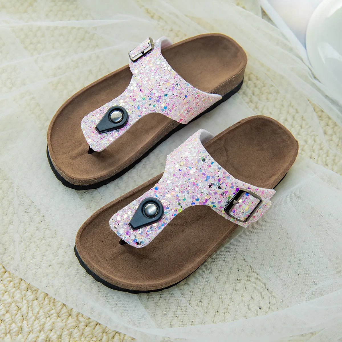 Gold, pink, and silver cork couples flip-flops with artificial leather upper and non-slip sole.