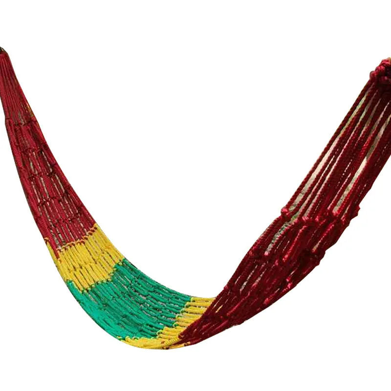 Nylon rope mesh hammock hung between two trees with tying rope visible