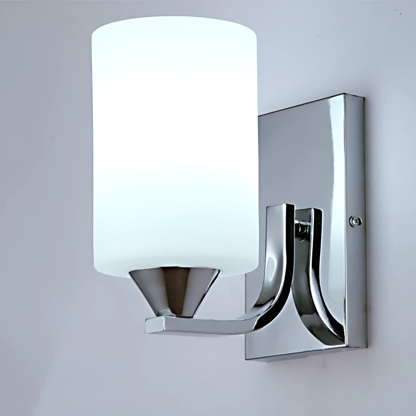 Modern chrome wall lamp with glass lampshade in single head configuration on white wall