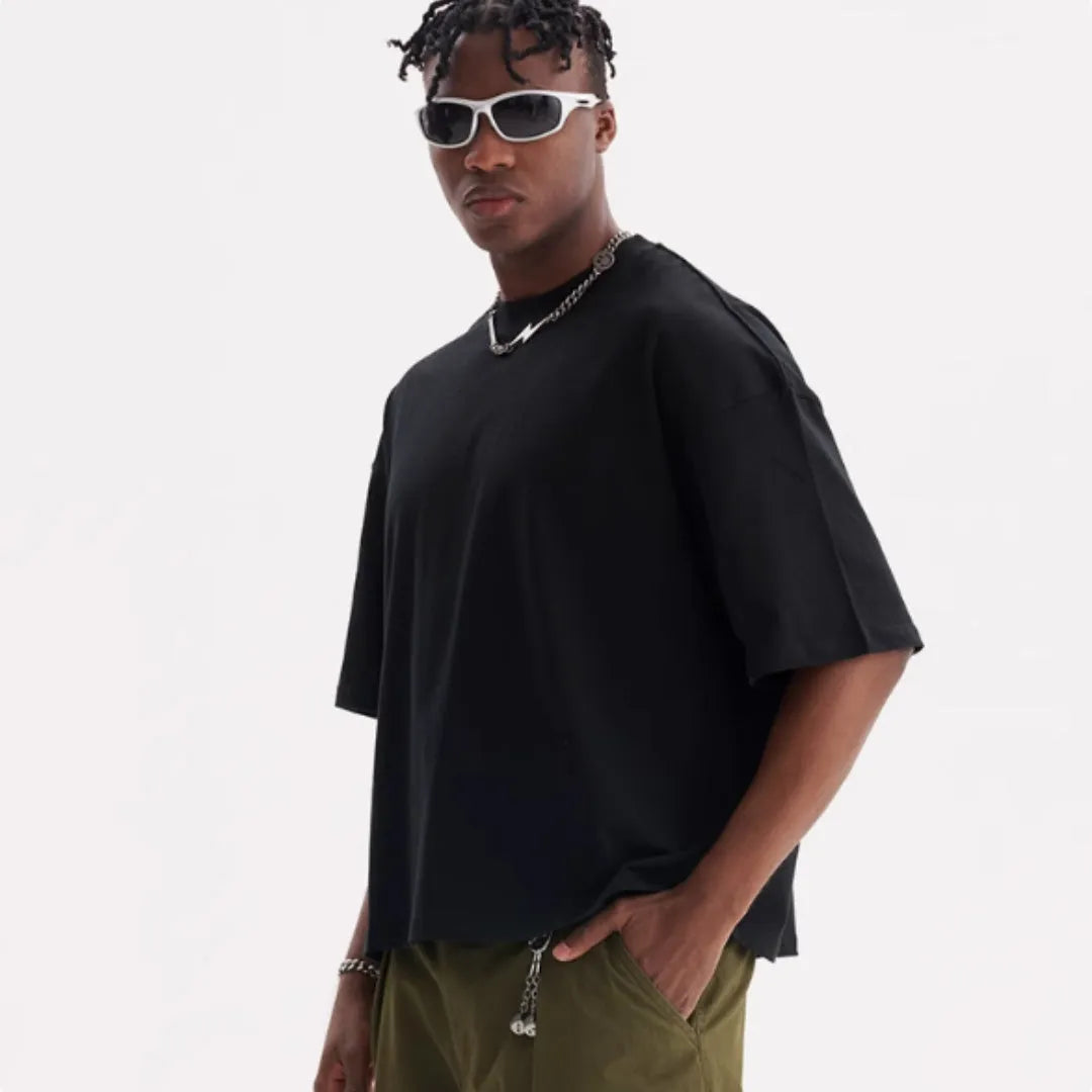 Man wearing a loose fit apricot coloured pure cotton t-shirt, short sleeves, casual American style.