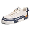 Men's white and green canvas casual shoes with mesh panels and a flat heel.