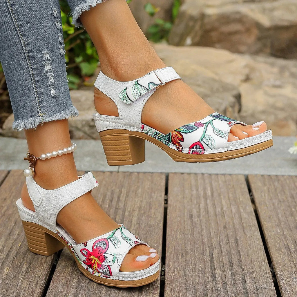 White women's high heel sandals with a Velcro strap buckle and rubber sole.