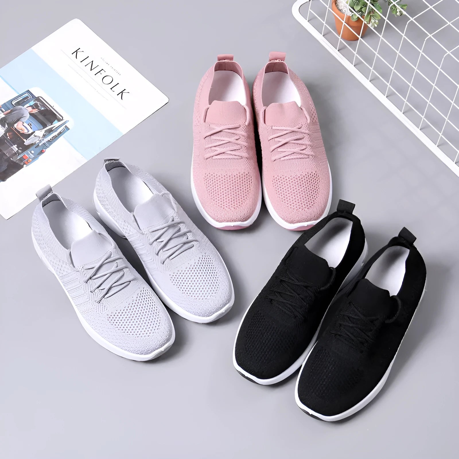 Women's black mesh casual sneakers with round toe and white lace-up front on a grey PVC sole.