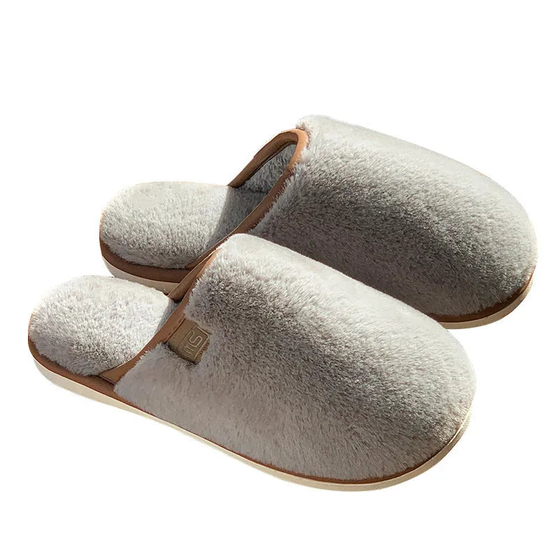 Solid colour PVC plush slippers with non-slip sole and car stitching detail on a wooden floor.