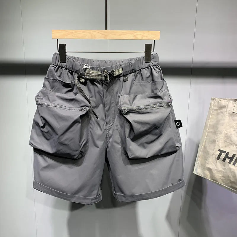 Men's black loose-fit cargo work shorts on a mannequin, showing multiple pockets and above-knee length.