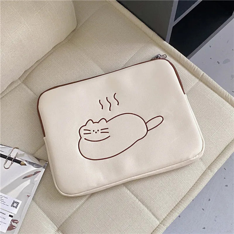 Embroidered fat cat design on a navy blue nylon tablet protective sleeve with a black zip.