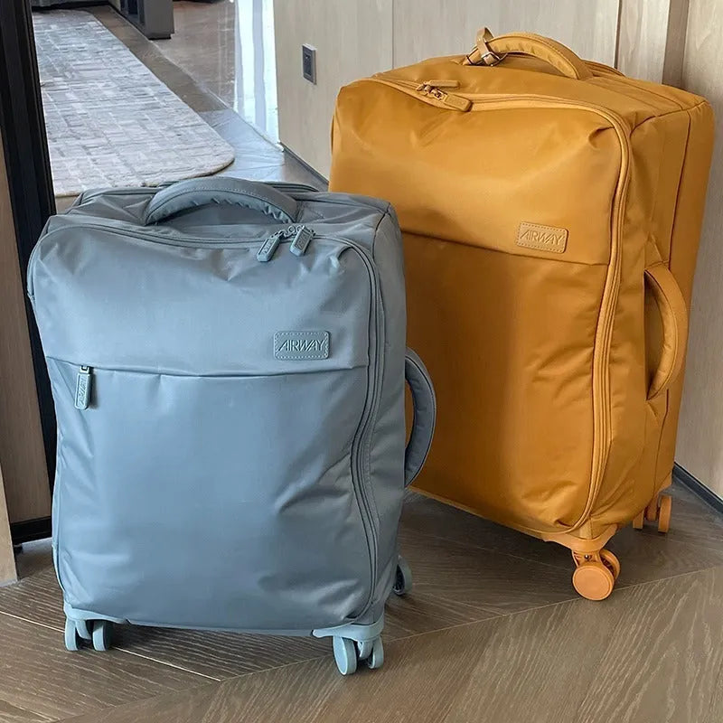 Ultra-light waterproof Oxford cloth suitcase with universal wheels in a bluestone green colour.
