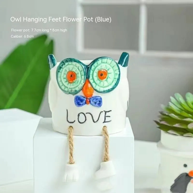 Cartoon style ceramic hanging foot flowerpot for succulent plants on a desktop.