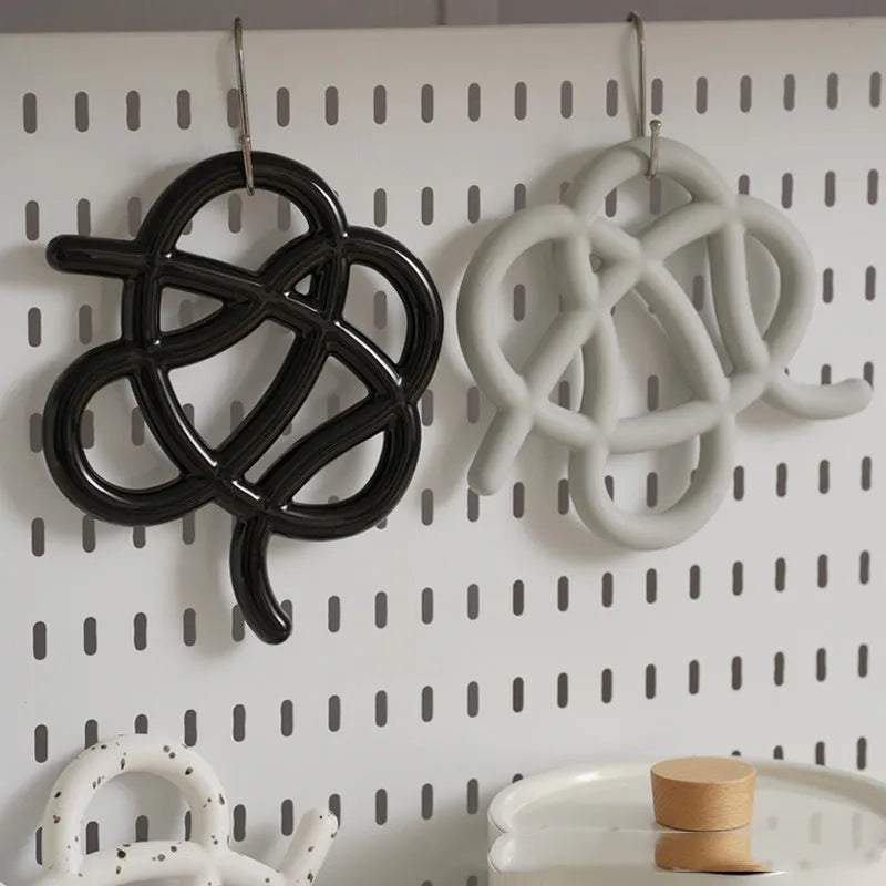 Ceramic heat proof mat in irregular shape on dining table surface