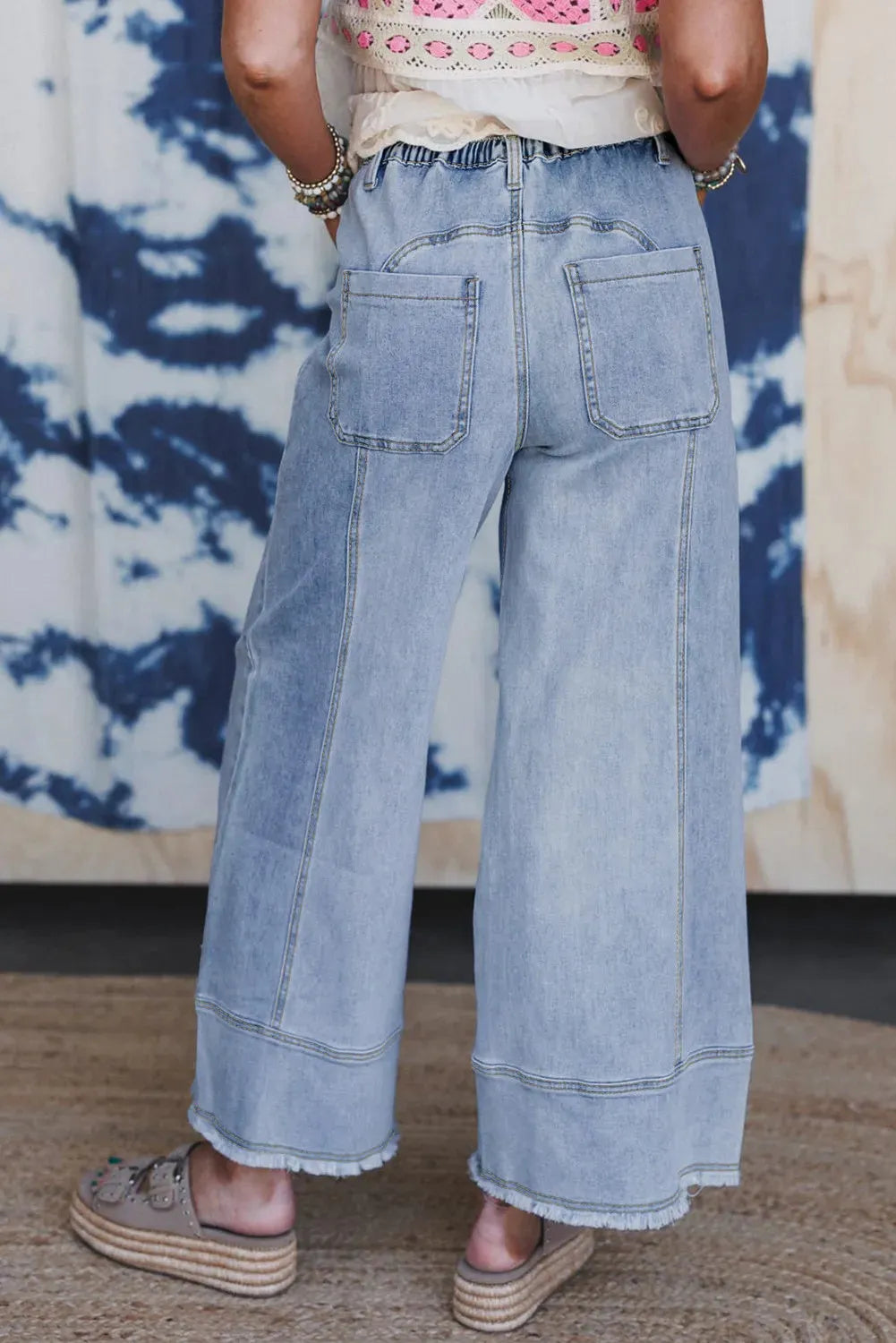 Beau Blue women's wide leg denim trousers with drawstring waist and raw hem.