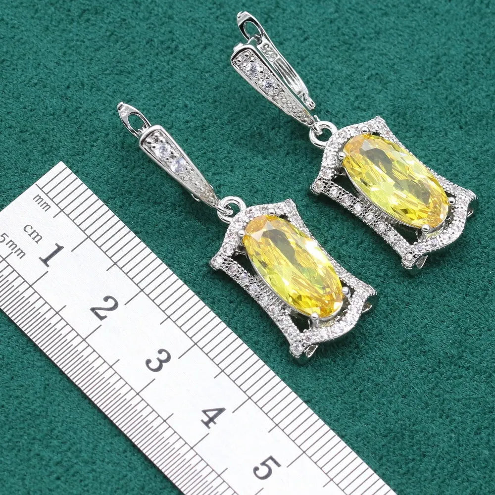 Yellow zircon jewellery set showing necklace with snake bones chain, matching earrings, ring, and bracelet on a white background.
