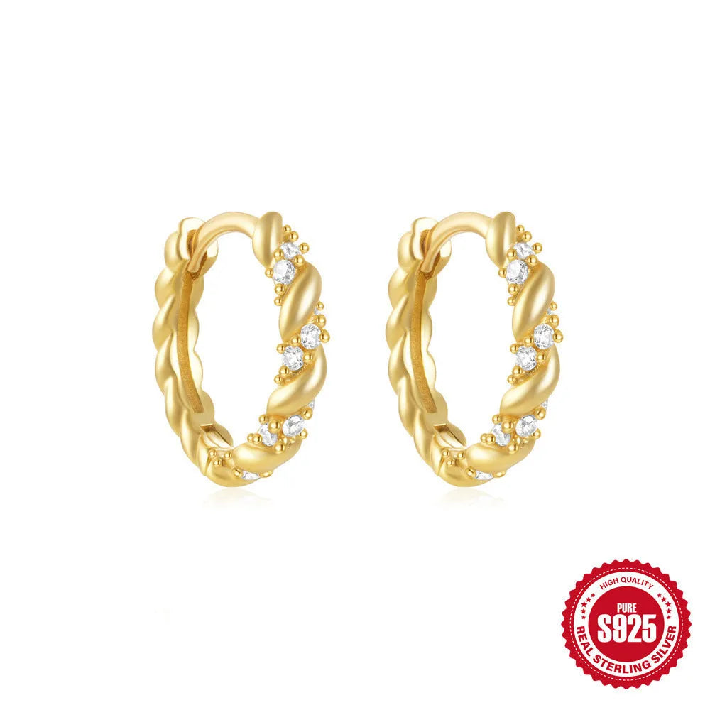 Sterling silver geometric stud earrings with a small round shape and classic diamond detail on a white background.