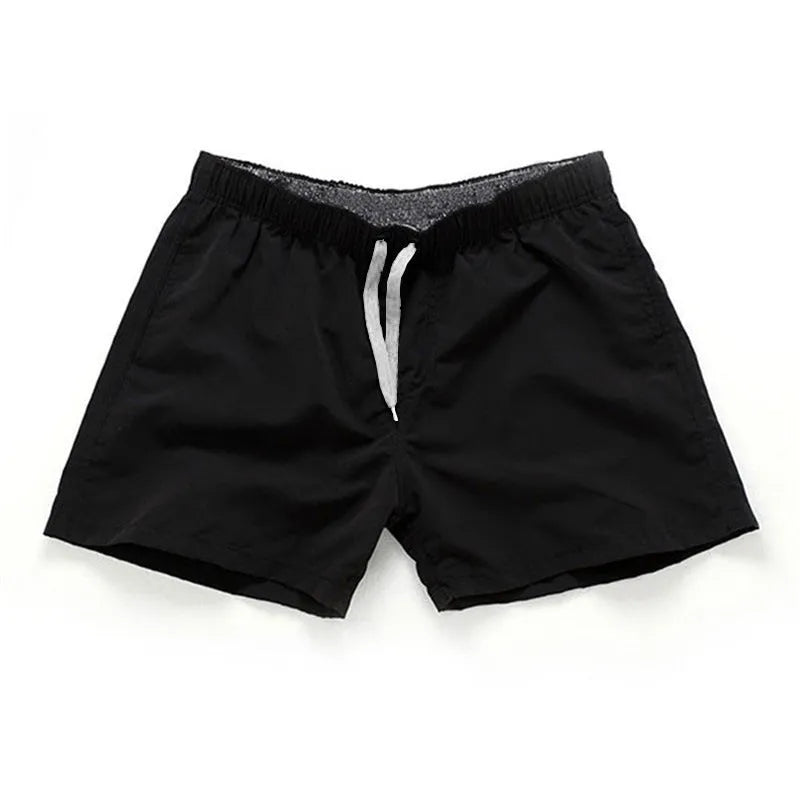 Men's polyester beach shorts with straight leg opening in multiple colours including black, white, and fluorescent yellow