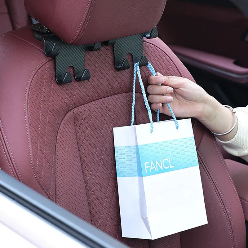 Black ABS plastic car hook and mobile phone bracket organiser for rear seat storage.