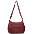 Trendy water-repellent nylon crossbody cloth bag in black with single shoulder strap and outer pocket