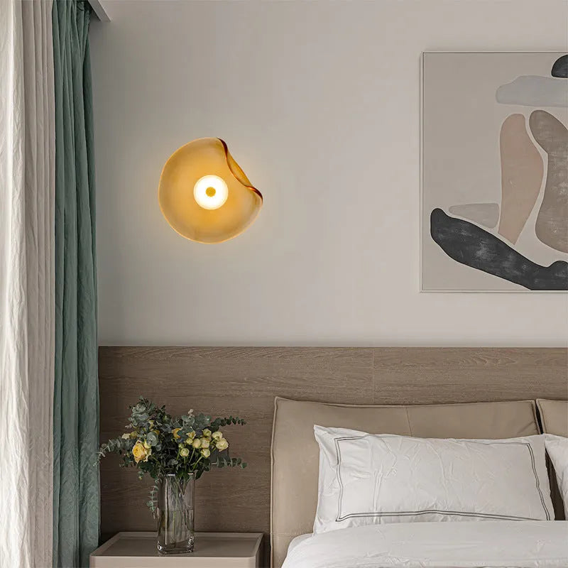 Round glass wall lamp for bedroom bedside in cognac, grey or light colour finishes.