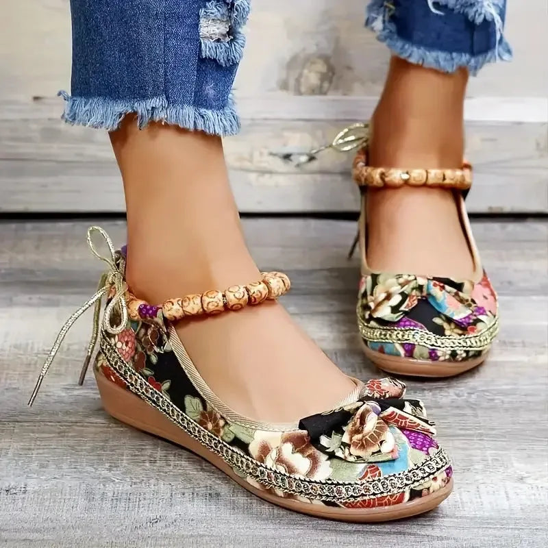 Women's ethnic platform sandals with elastic band closure in black colour showing cloth upper and round toe design