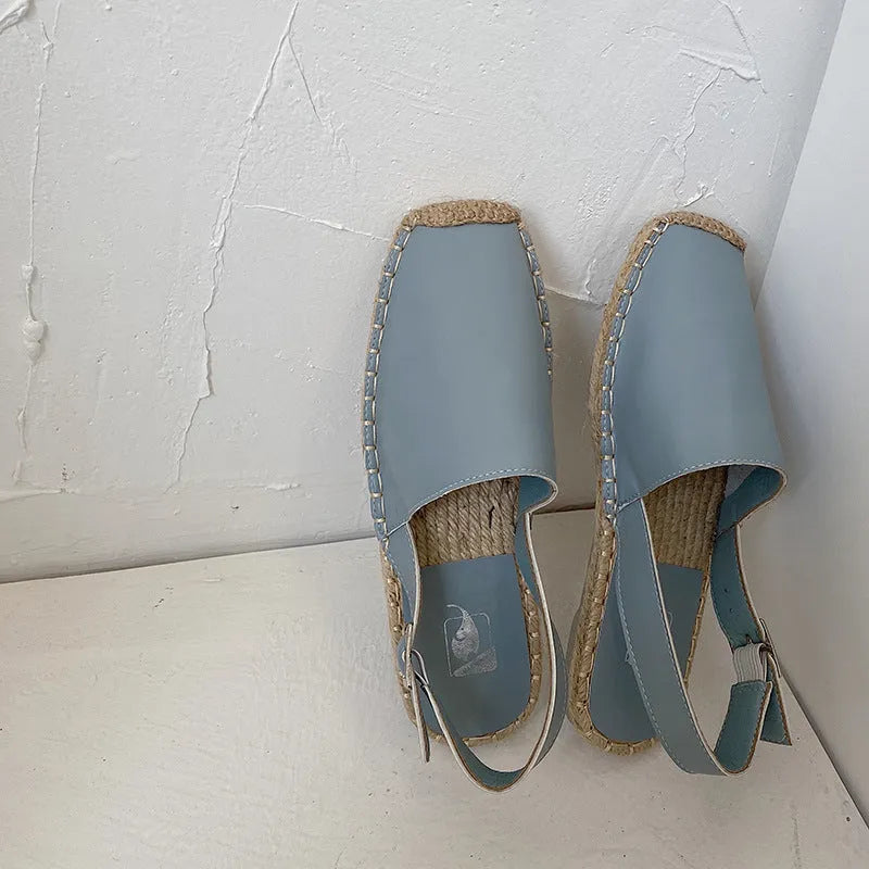 Women's beige retro fisherman flat sandals with canvas upper and animal pattern detail.