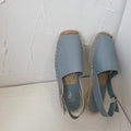 Women's beige retro fisherman flat sandals with canvas upper and animal pattern detail.