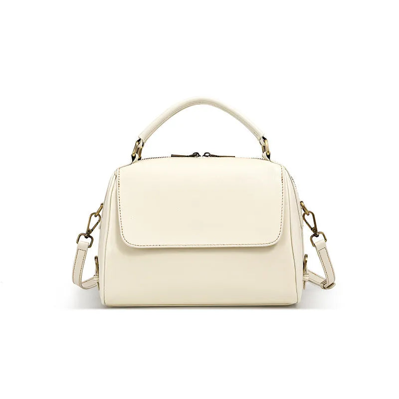Women's genuine leather crossbody tote bag in apricot colour showing internal compartments and shoulder straps.