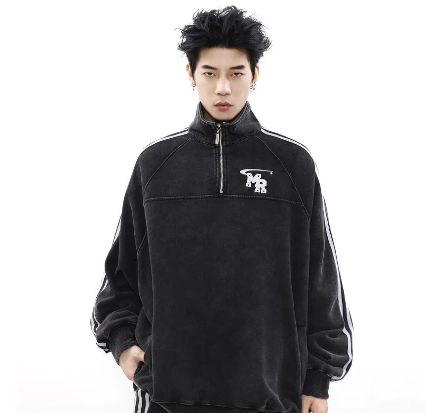 Black retro style men's stand collar hoodie jacket on a grey background.