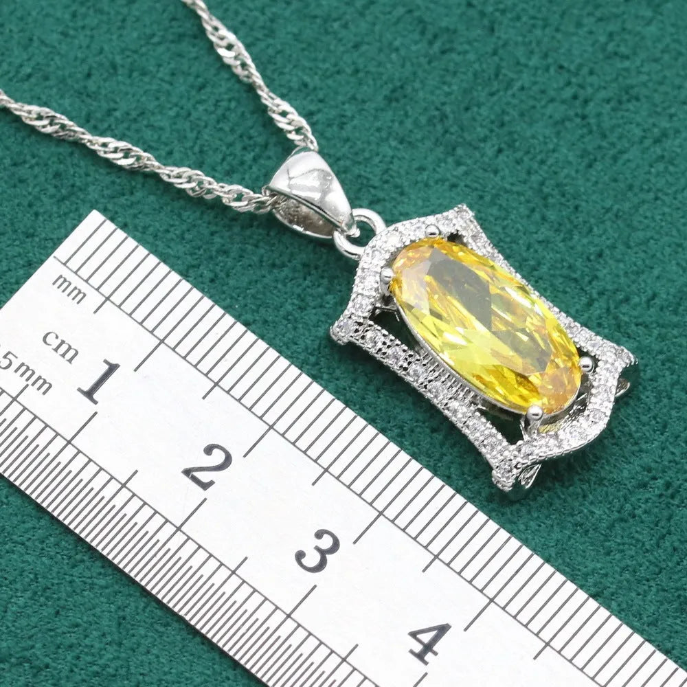Yellow zircon jewellery set showing necklace with snake bones chain, matching earrings, ring, and bracelet on a white background.