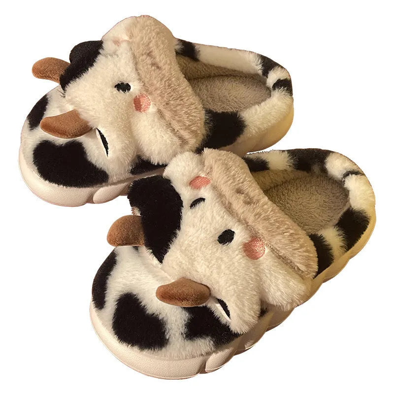 White plush cow slippers for women with a non-slip textured sole.