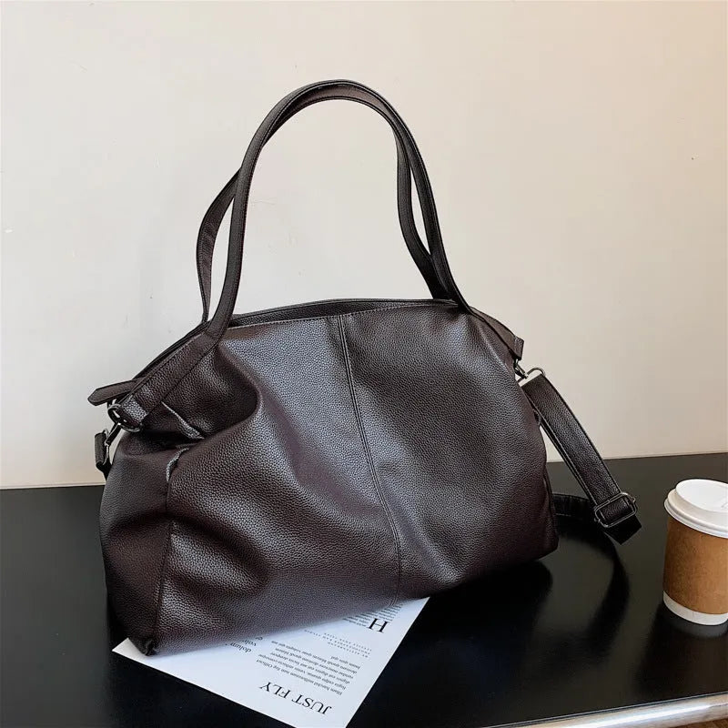 Soft surface messenger bag with adjustable strap showing mobile phone pocket and zipper compartments