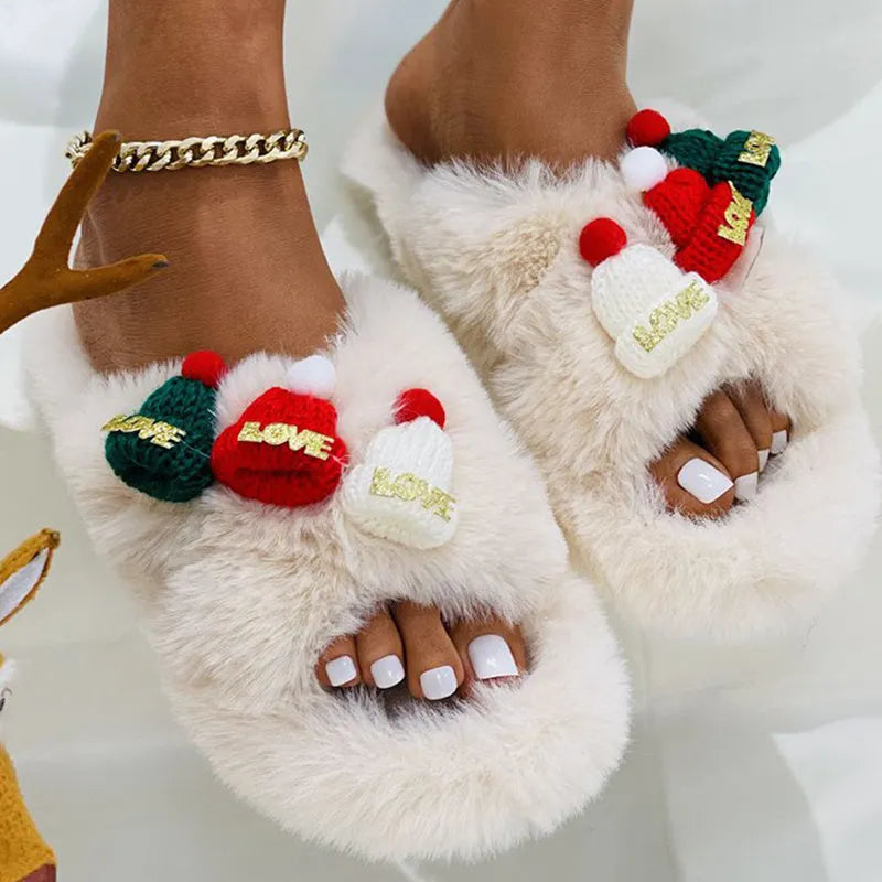 Women's black Christmas slippers with Santa hat decoration on plush faux fur upper.