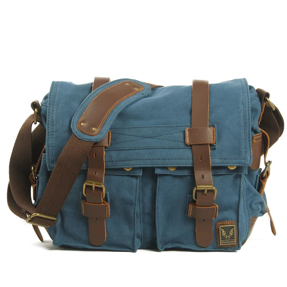 Men's brown retro canvas crossbody shoulder bag with cowhide trim, shown with flap open revealing internal zip pockets.