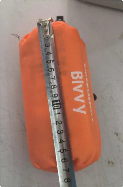 Orange emergency survival tent with sleeping bag and blanket for disaster relief