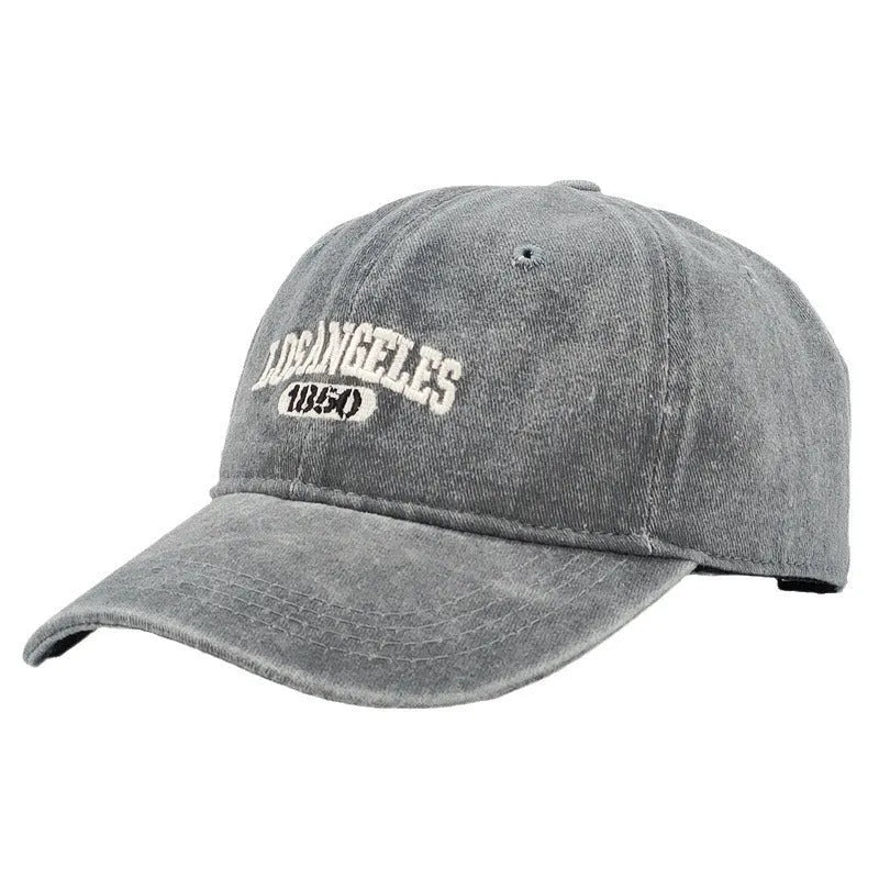 Retro peaked cap with distressed letter embroidery and adjustable sizing in conical crown design