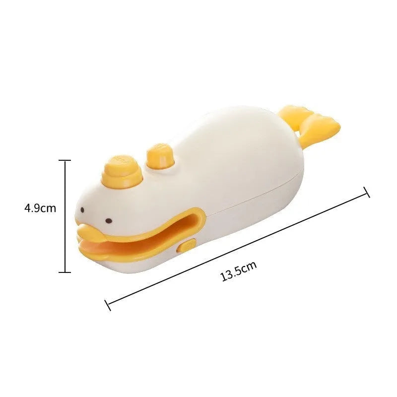 Small yellow duck shaped rechargeable sealing machine with charging cable on a white background.