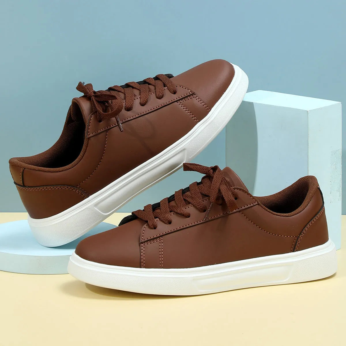 Beige brown platform skateboard sneaker with low top, round toe, and cross-belt design on a white background.