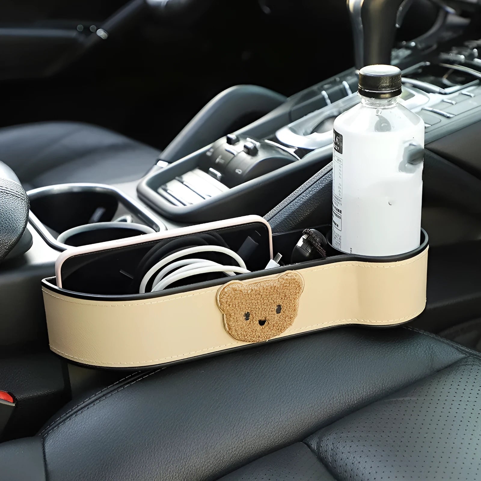 Leather car seat gap storage box with a cartoon bear design hanging between vehicle seats.