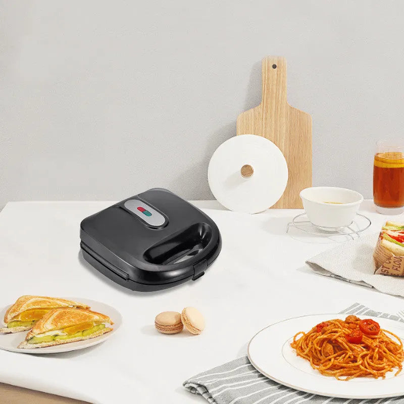 Black electric sandwich pan with double-sided heating, brushed stainless steel cover, and non-stick cooking surface